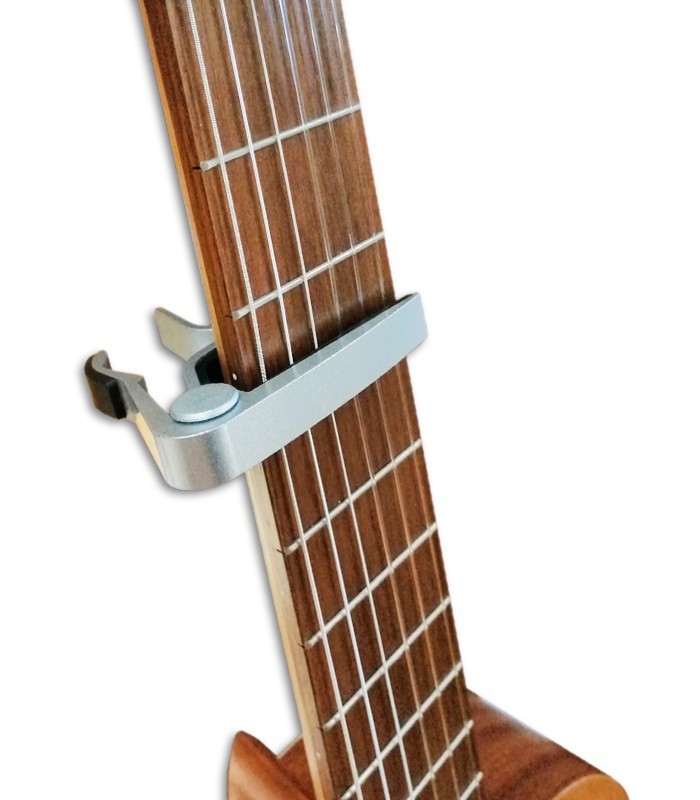 Photo of the Capo Leon model SC-03C placed on the neck of a guitar