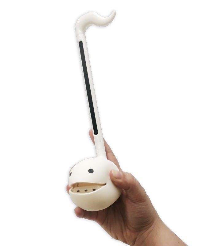 Otamatone model Original white held by a hand