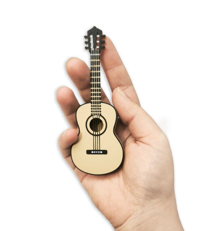 Classical guitar shaped pick holder on a hand